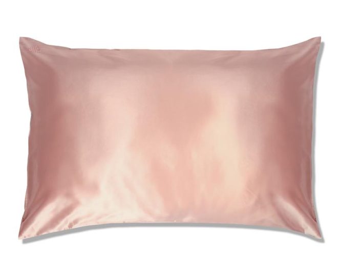 Pink Colored Silk Pillowcase Displayed On A White Background