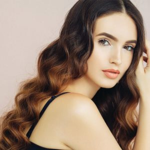 Young Lady Showing Off Her Hair By Moving Her Hands Through Them