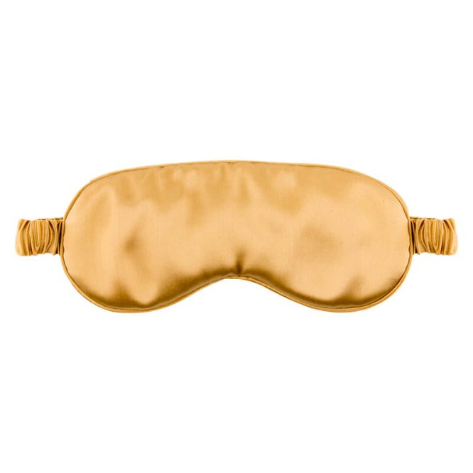 Gold Colored Silk Sleep Mask Displayed On A White Background